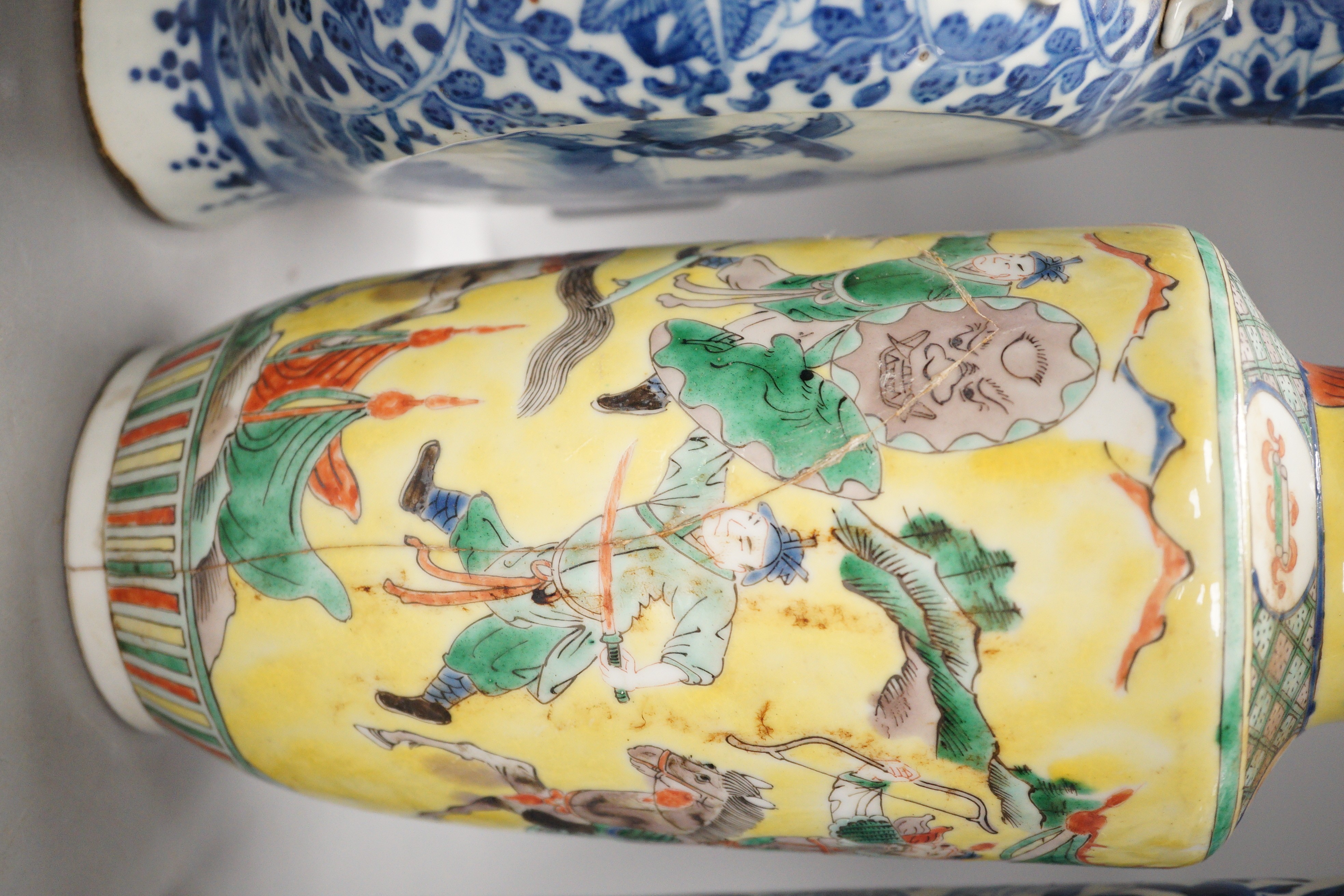 A Chinese famille verte vase and cover, a yellow ground ‘soldiers’ vase, a blue and white moonflask and a similar’dragon’ sleeve vase, all late 19th/early 20th century, Tallest 33cm